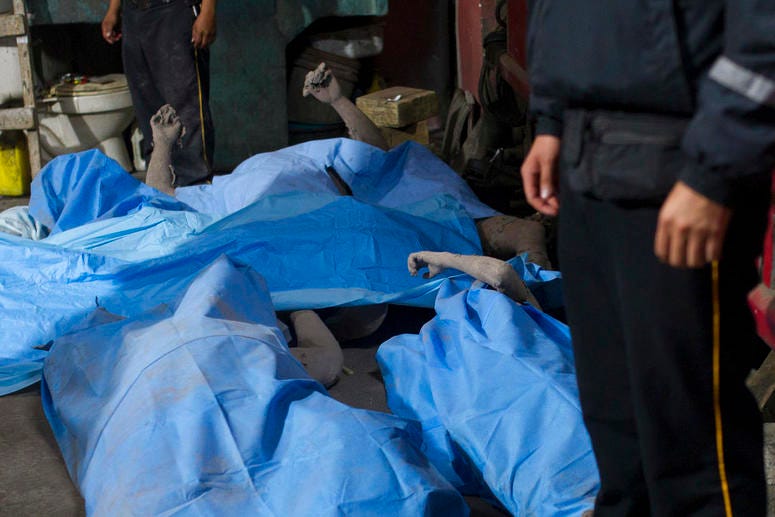 Bodies are laid in a temporary morgue near Volcan de Fuego, or Volcano of Fire, in Alotenango, Guatemala. Bodies are laid in a temporary morgue near Volcan de Fuego, or Volcano of Fire, in Alotenango, Guatemala.
